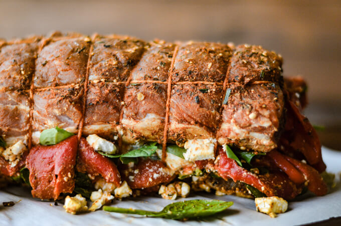 A tied rolled pork roast stuffed with spinach, roasted red peppers and feta cheese.