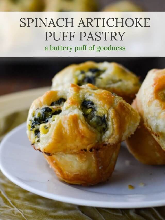 Three spinach stuffed puff pastry appetizers with more appetizers in a muffin tin in the background.